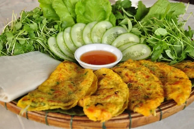 A delicious spread of Vietnamese dishes, including Banh Xeo, served at a local home in Go Noi during a Local Tour Hoi An.