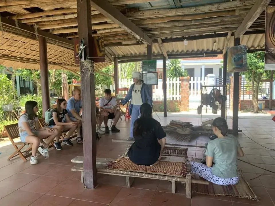 Learning traditional mat weaving, a peaceful cultural experience away from the bustling Hoi An Handicraft Tours