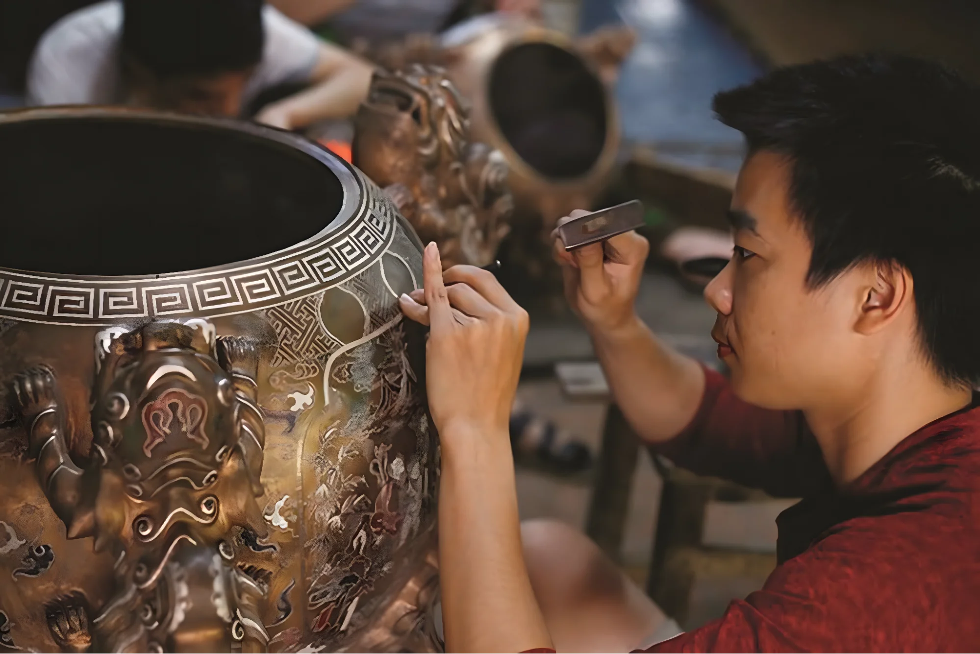 A local artisan demonstrates the traditional art of bronze casting at a craft village near Hoi An during My Son Sanctuary tour.