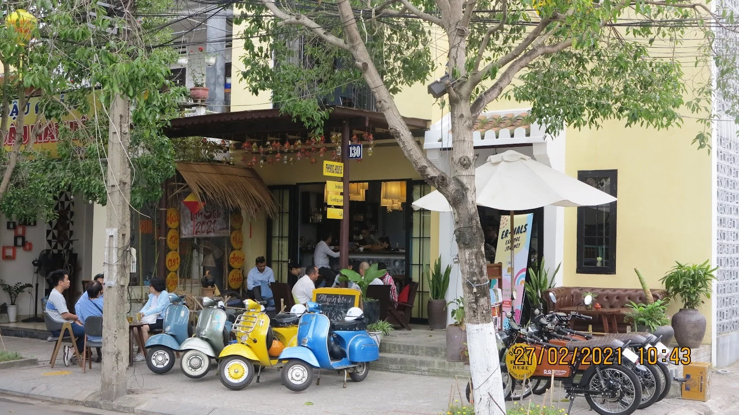 Visitors enjoying freshly roasted coffee on a scenic Vespa tour Hoi An style.