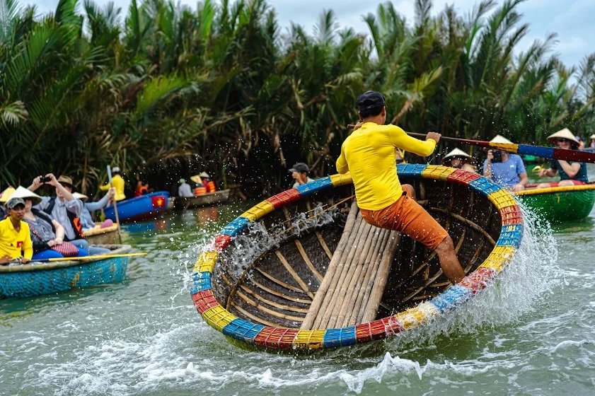 Tourists navigating canals in basket boats at the Bay Mau Coconut Forest