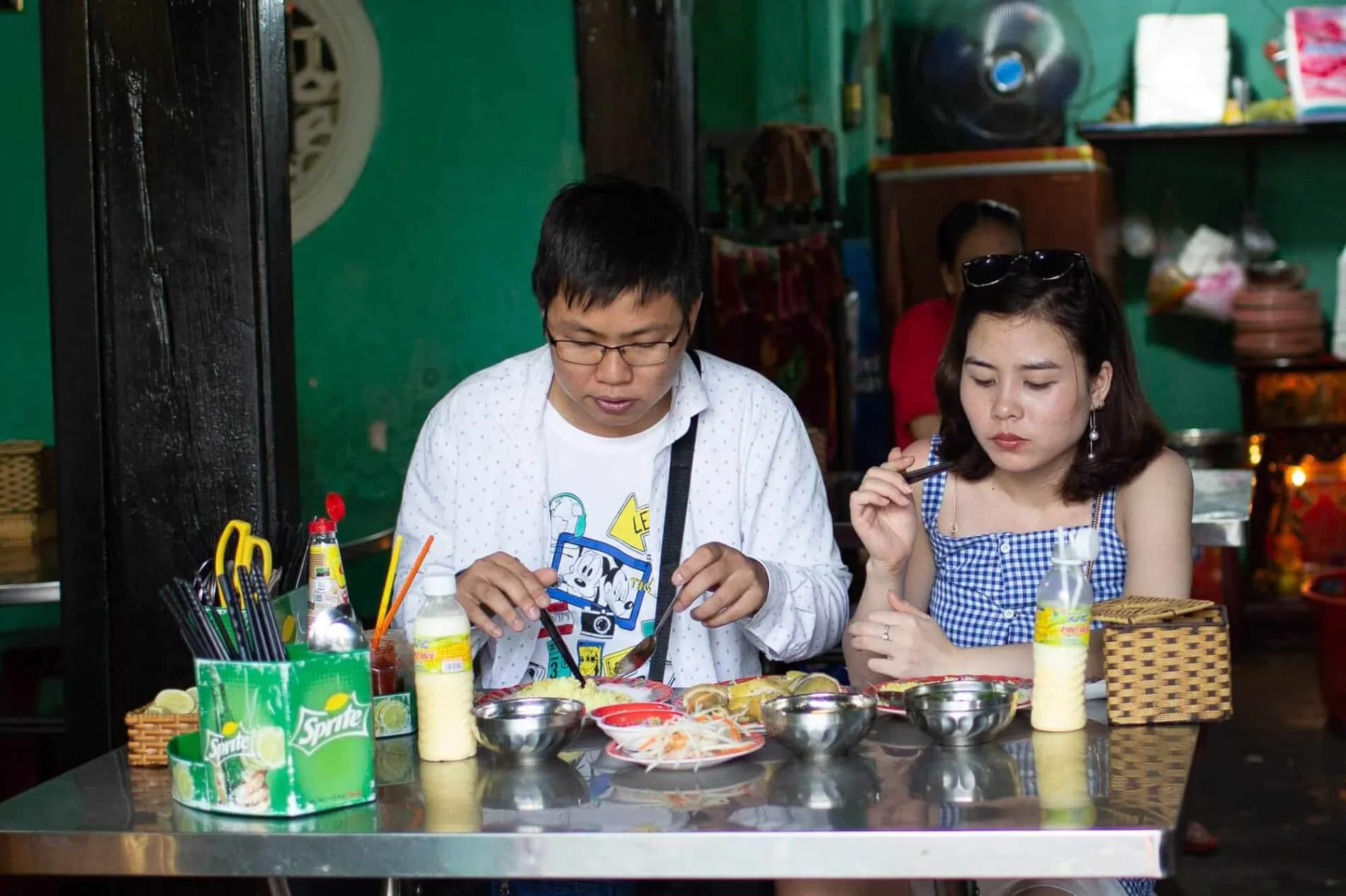 Couple enjoying Hoi An chicken rice at a local restaurant
