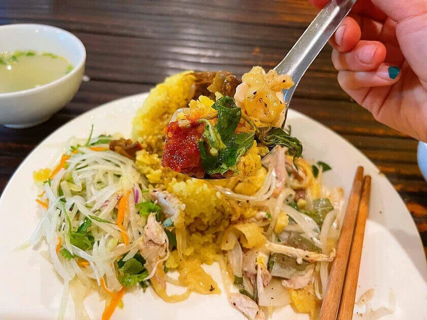 Close up of Hoi An chicken rice with shredded chicken and herbs
