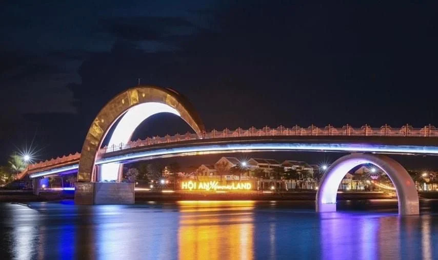 glowing moon bridge leading visitors toward the grand venue of the Hoi An Memories Show