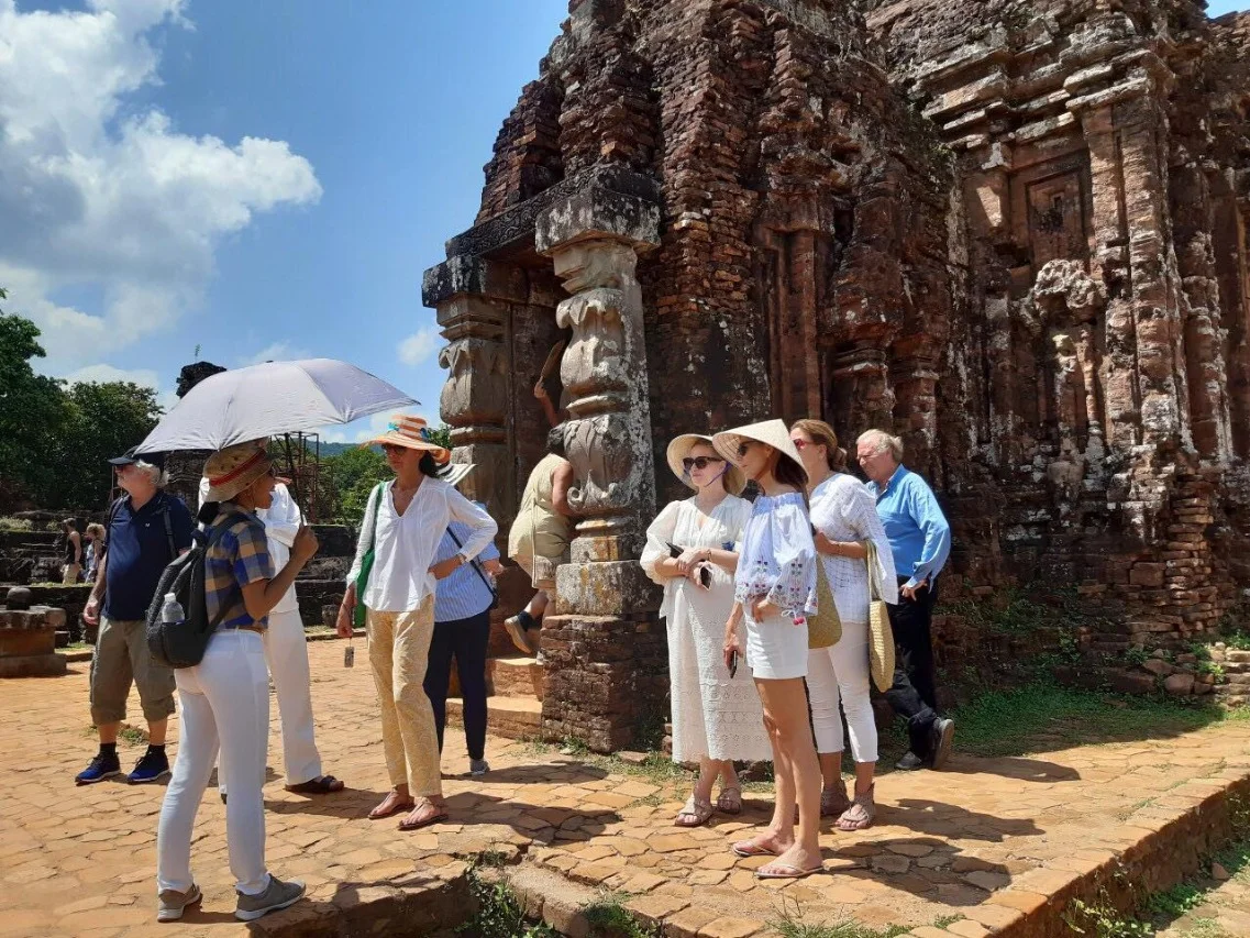 Tourists exploring the ancient ruins at My Son Sanctuary.