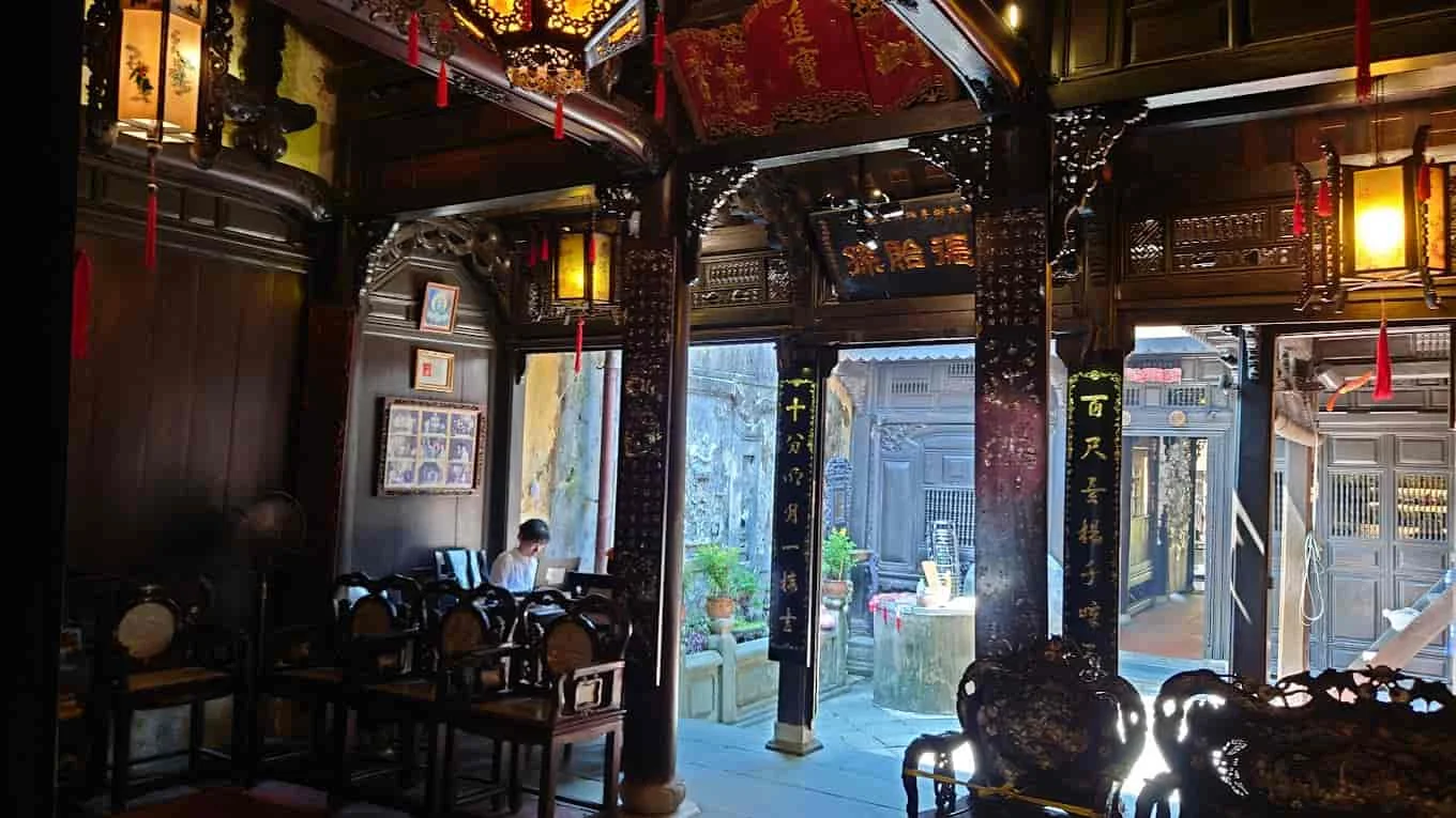 Intricate carvings and lanterns inside Tan Ky Ancient House