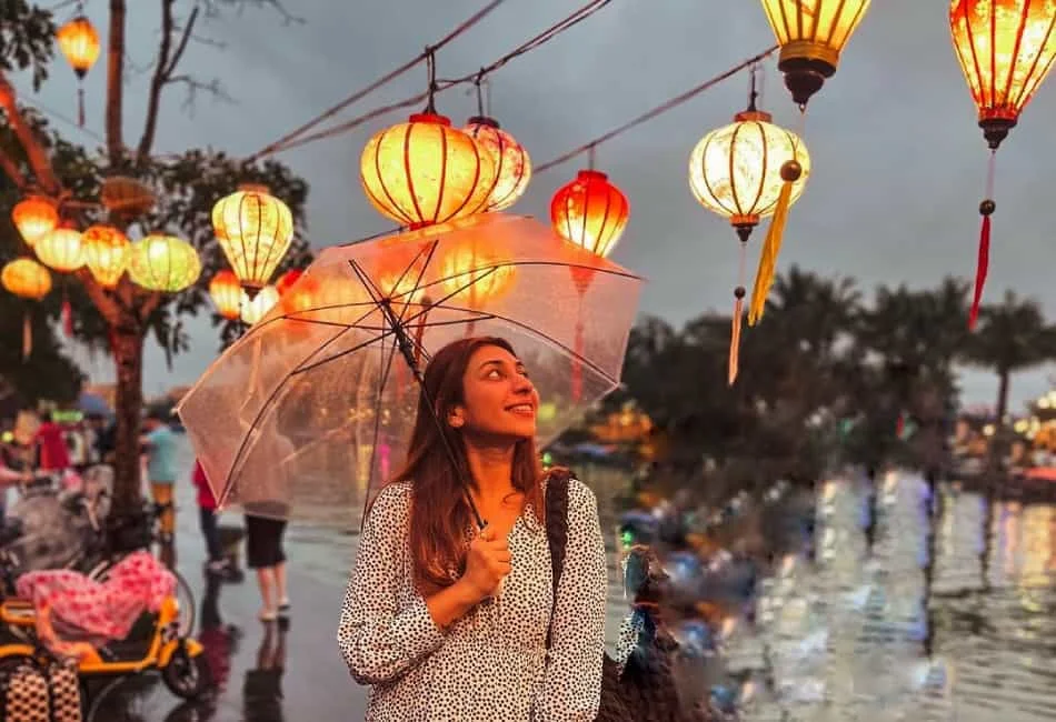 woman with umbrella under lanterns at Hoi An Market