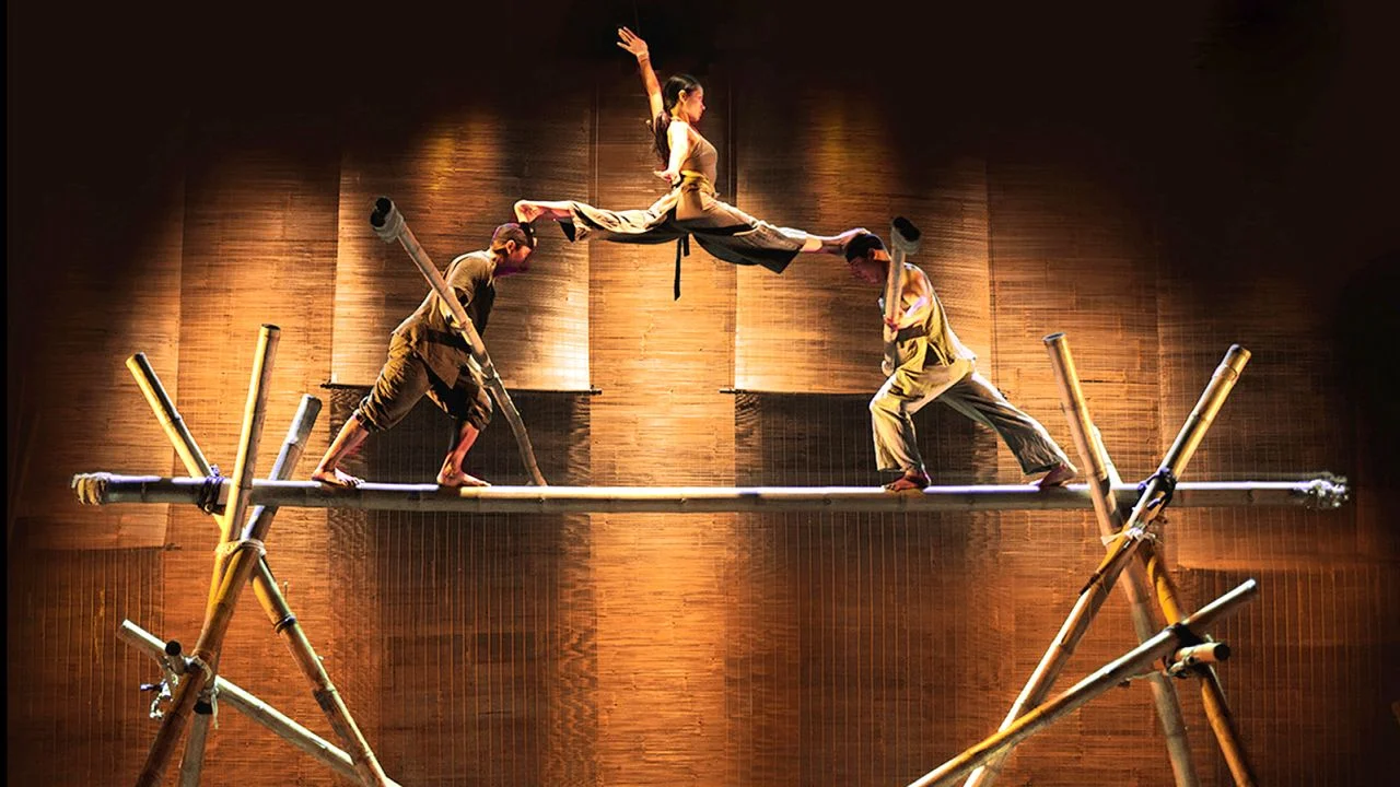 Acrobats perform a graceful balancing act with bamboo props on stage at the Bamboo Circus Hoi An.