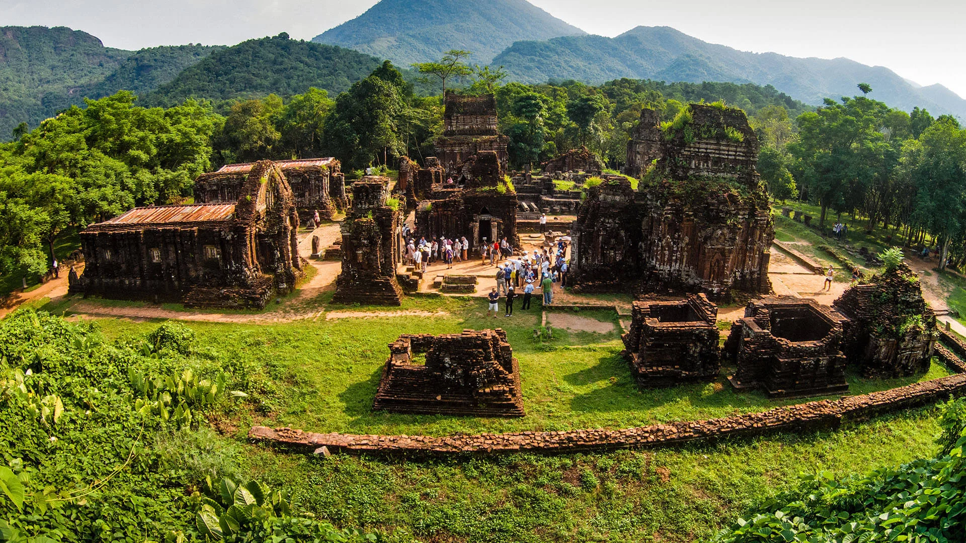 Tourists exploring the ancient ruins at My Son Sanctuary.
