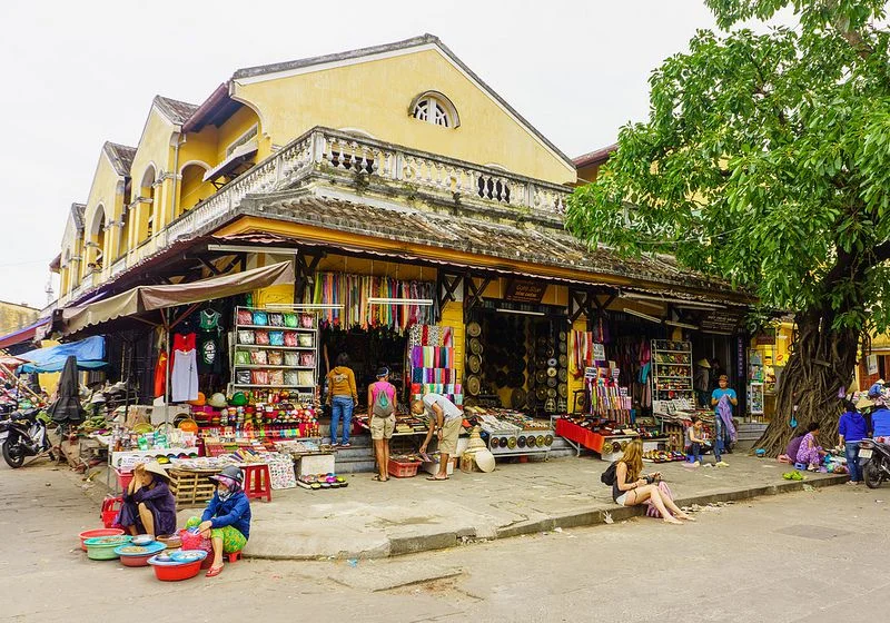 Stalls selling colorful fabrics and souvenirs at Hoi An Market