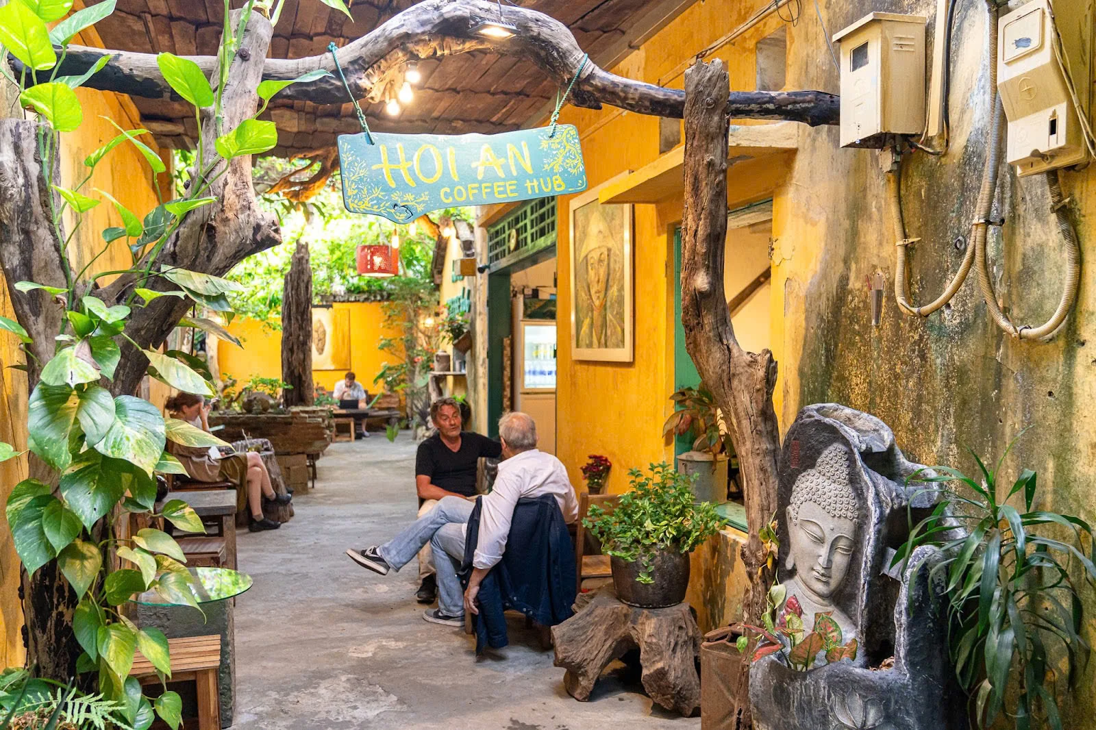 People relaxing at Hoi An Coffee Hub, enjoying coffee.