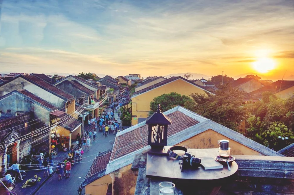 sunset view over ancient tiled roofs from a hoi an coffee shop