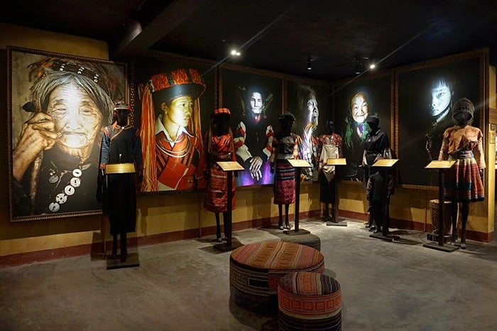 large portraits and traditional ethnic costumes displayed in the Precious Heritage Art Gallery Museum in Hoi An