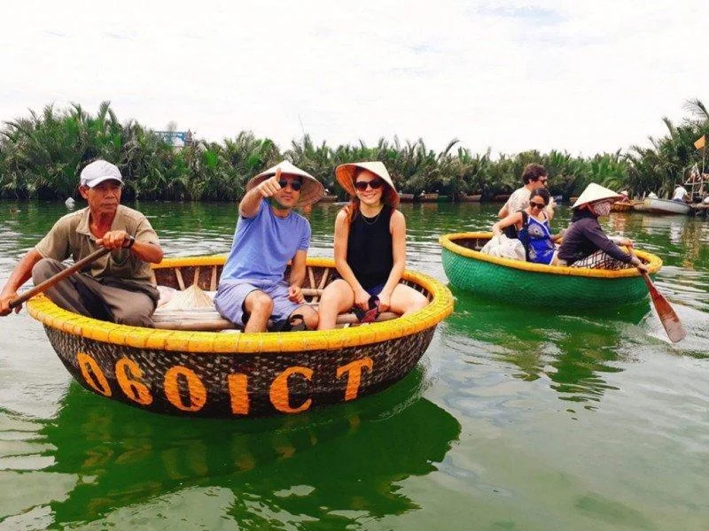 tourists and local guides enjoying a basket boat ride during a Bay Mau Coconut Forest tour
