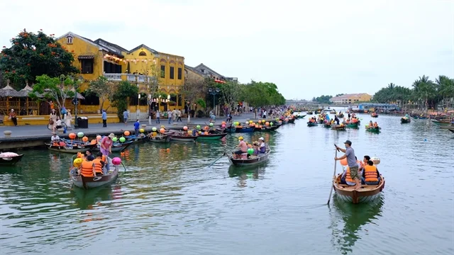 Boats full of tourists on the river near Hoi An Market