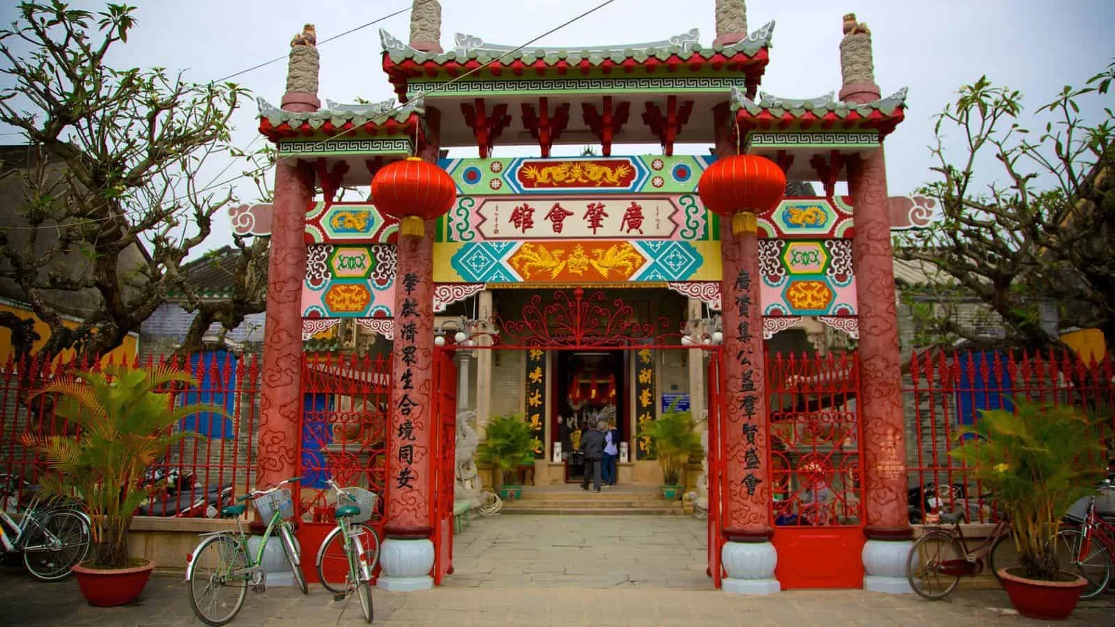 The vibrant, ornate entrance to the Cantonese Assembly Hall, with red lanterns and detailed traditional decorations.