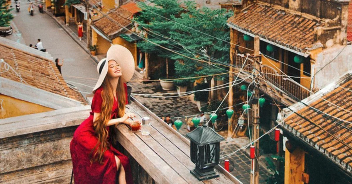 woman enjoying coffee from a rooftop, one of the best Hoi An coffee shops with view