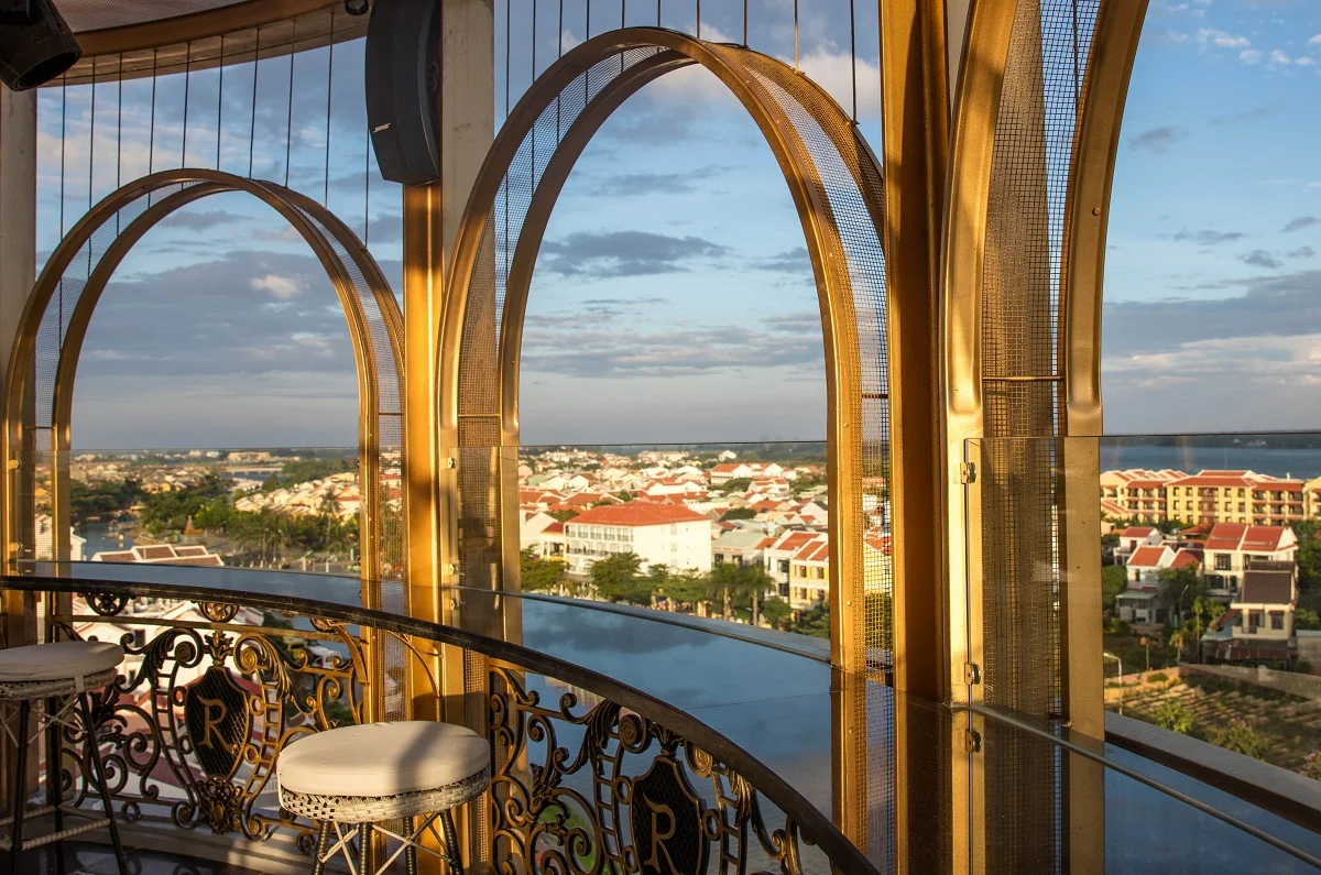 panoramic view of Hoi An's charming red-roofed town and distant river from an elevated bar, perfect for a day trip to Hoi An from Da Nang