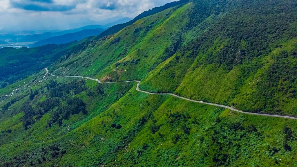 Scenic winding road on a mountainside, perfect for a Hue to Hoi An motorbike tour