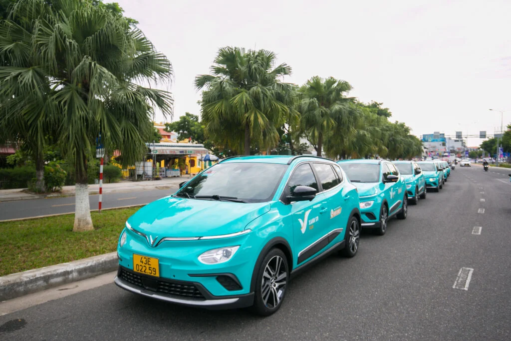 Line of bright turquoise cars, a convenient option for exploring Hoi An.