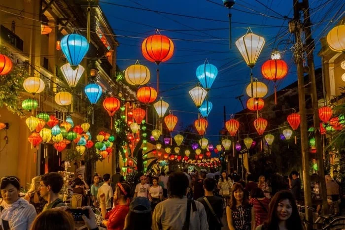 Exploring the colorful streets, one of the top things to do in Hoi An at night.