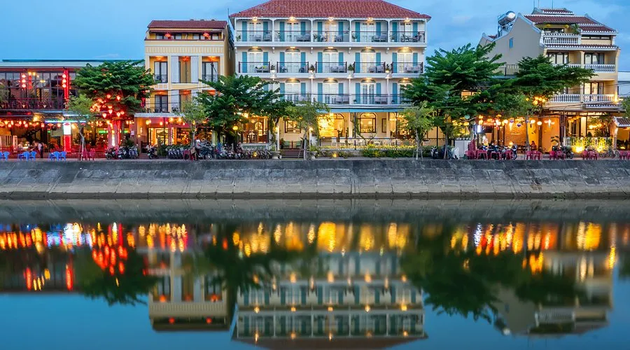 Lantana Boutique Hoi An Hotel reflecting on the calm river, near Cam Pho communal house