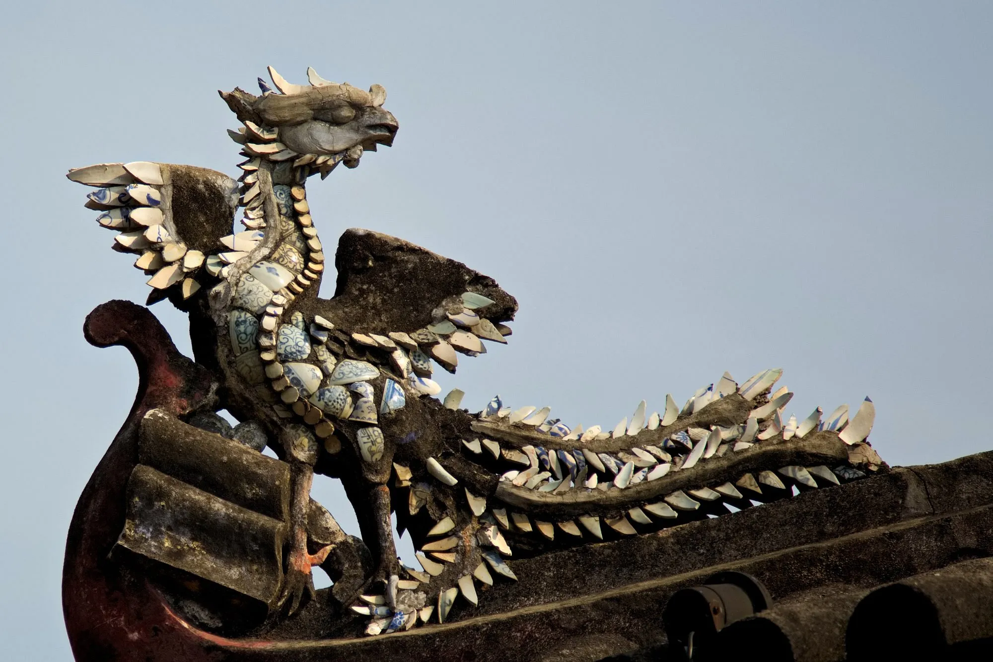 Porcelain mosaic of a mythical bird on the roof of Cam Pho Communal House.