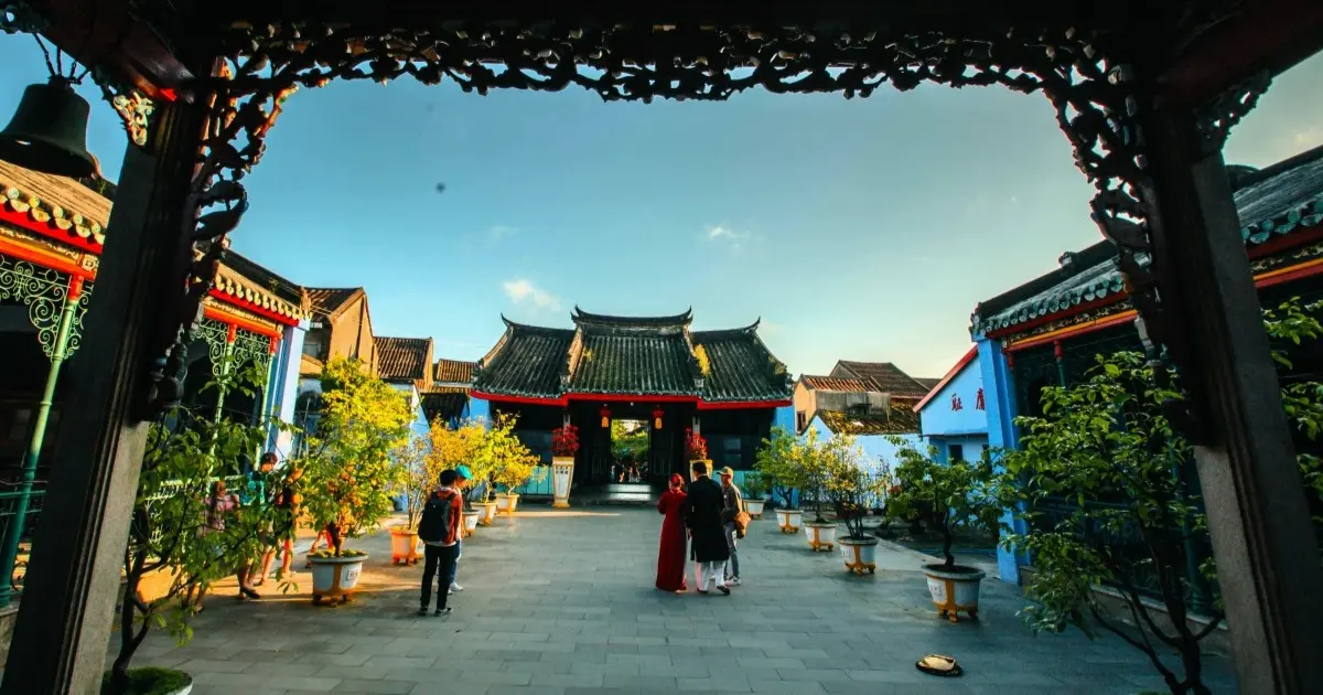 Ornate archway framing the courtyard of Cantonese Assembly Hall Hoi An