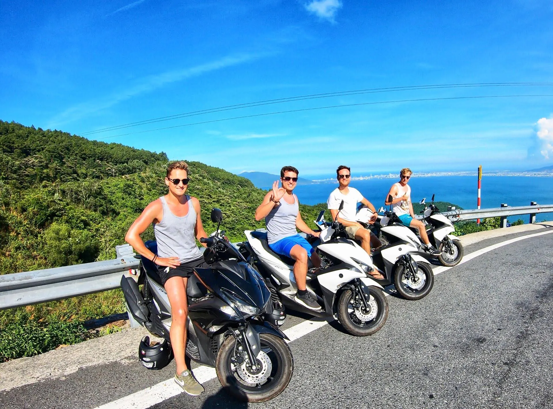 Group on an electric bike rental Hoi An ride on a scenic mountain road.