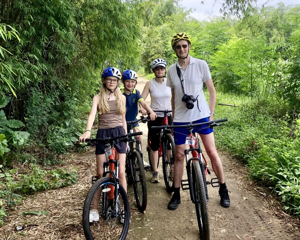 Family on a mountain bike rental Hoi An adventure through rural trails.