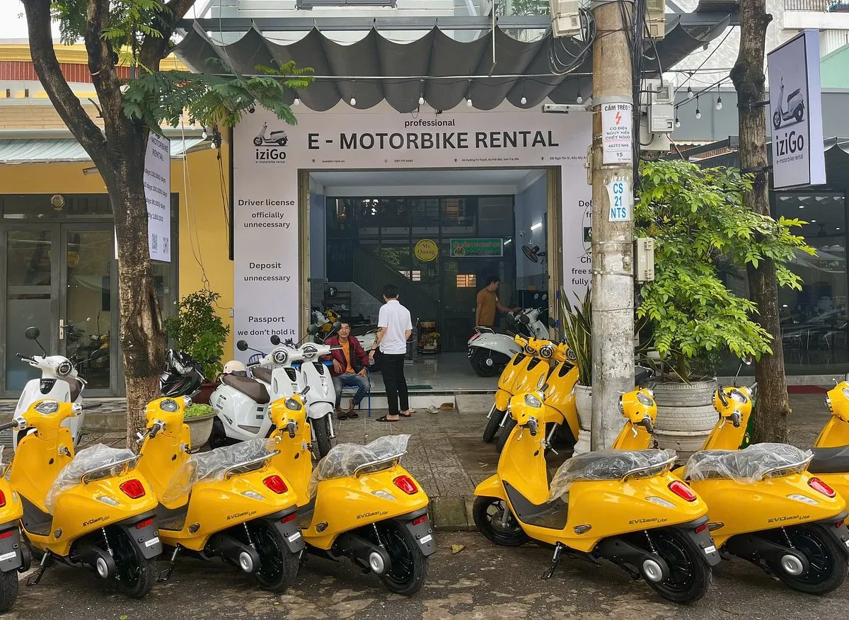 Yellow e-bikes parked outside a professional electric bike rental Hoi An store.