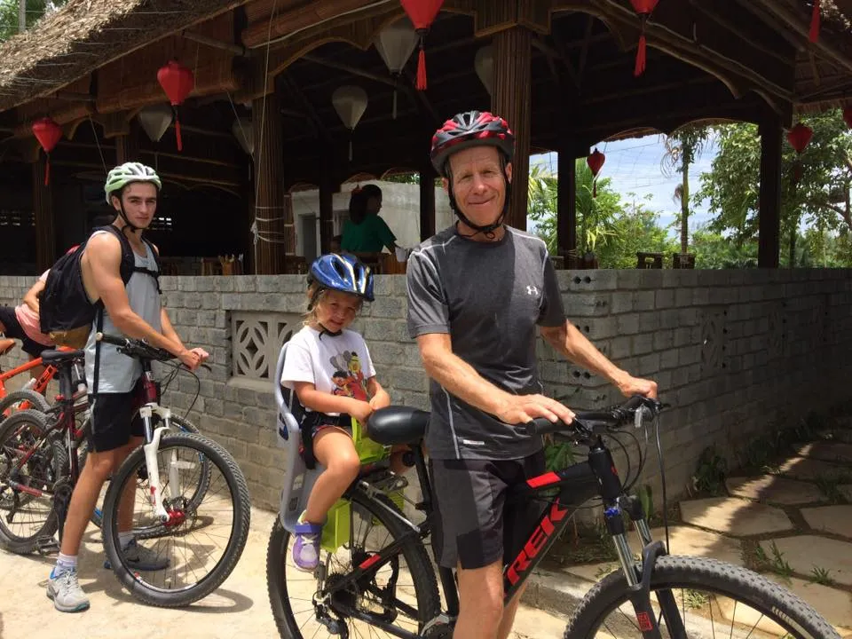 Family preparing for a mountain bike rental Hoi An trip in the countryside.