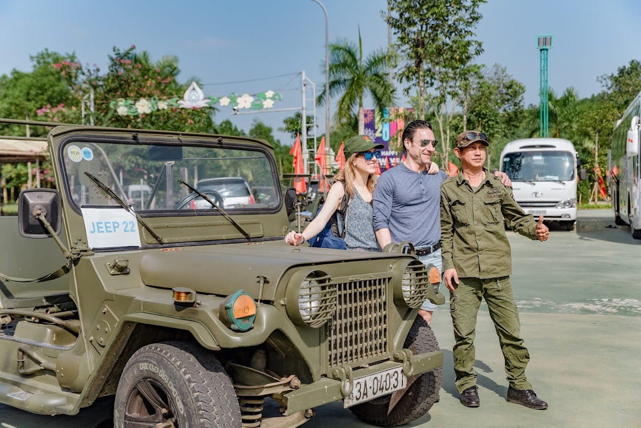 Restored US Army Jeep carrying tourists along the Thu Bon River in Hoi An