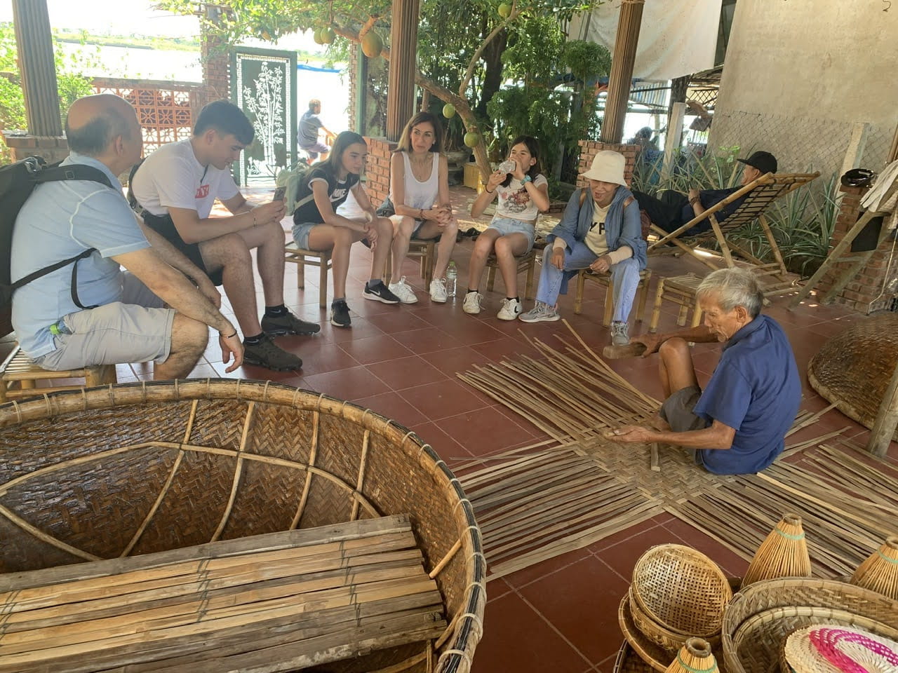 Visitors learning traditional basket weaving in Tra Nhieu Village, Hoi An