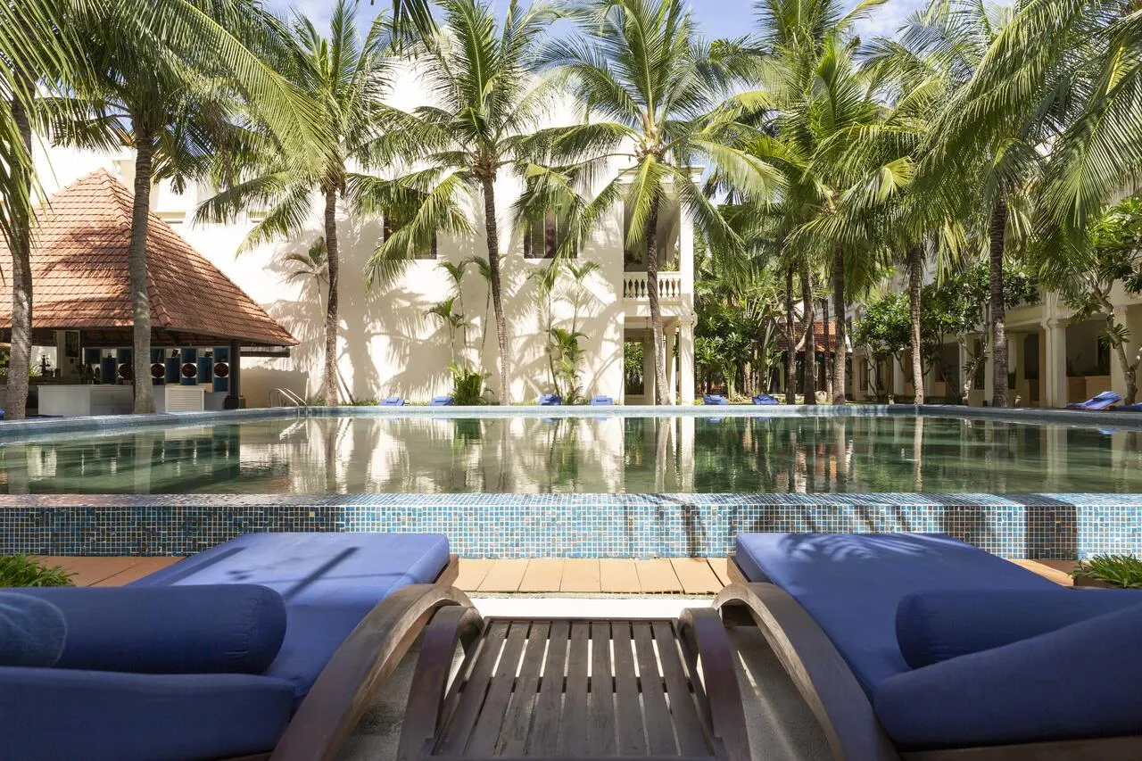 Anantara resort pool with blue loungers located near quan am pagoda hoi an.