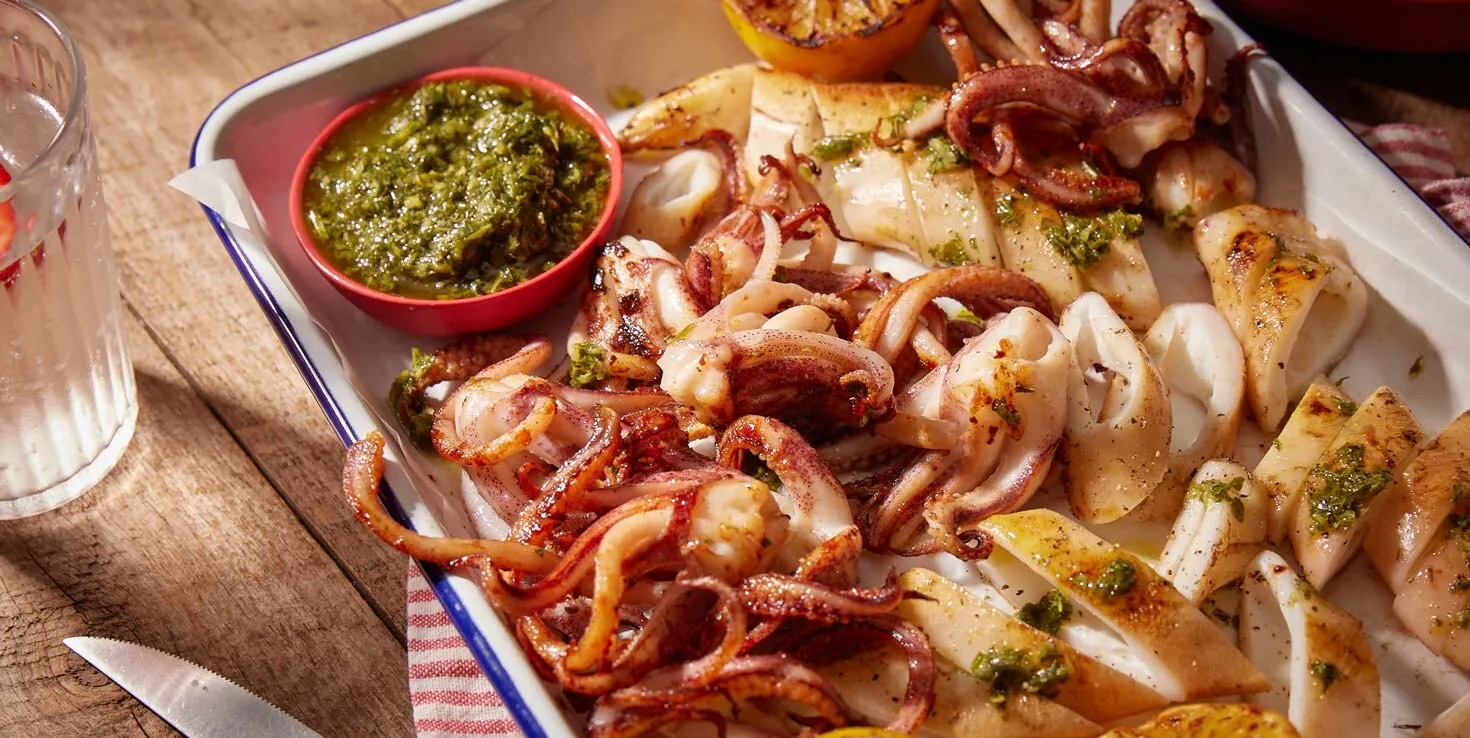 Fresh charcoal-grilled squid served at a beachfront seafood restaurant near Tam Thanh Mural Village.
