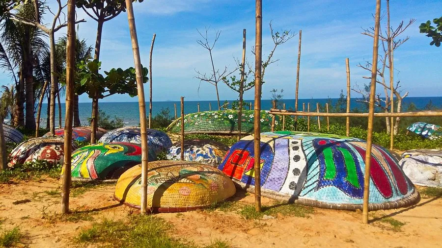 Painted traditional coracle boats on the sandy coast of Tam Thanh Mural Village.