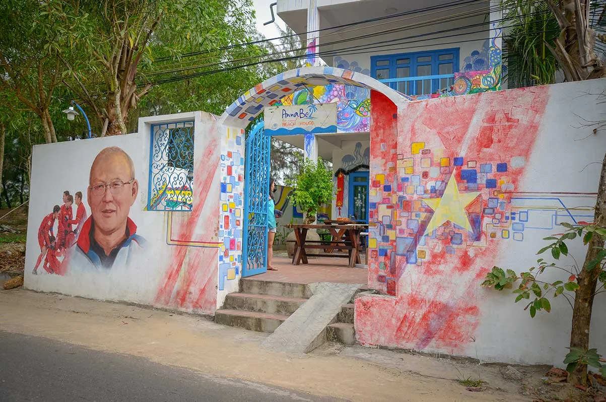 Football coach mural on a colorful house wall in Tam Thanh Mural Village.