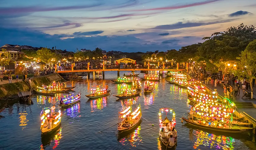 Vibrant night scene with colorful lantern boats on the Thu Bon River Hoi An, Vietnam.