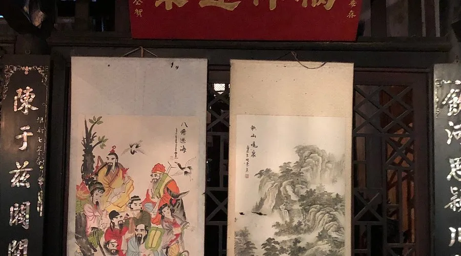 Traditional scroll paintings and carved wooden pillars inside the Tran Family Chapel.