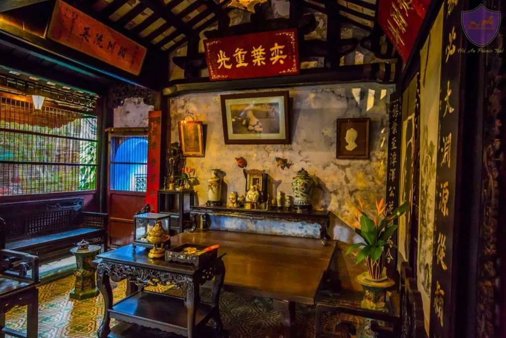 Interior of Tran Family Chapel with a wooden altar, vintage tiles, and Han characters.