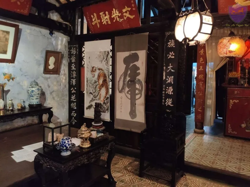 Calligraphy scrolls and antique ceramics inside the Tran Family Chapel.
